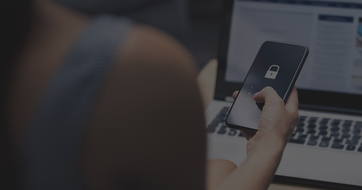 A person checking their phone to see if their information was compromised in a data breach.