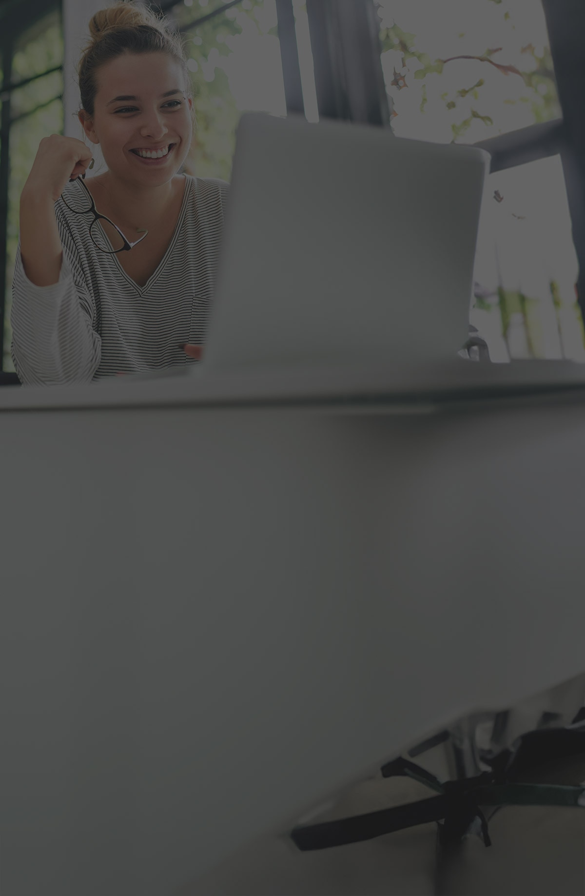 A woman sitting at a computer learning about identity theft.