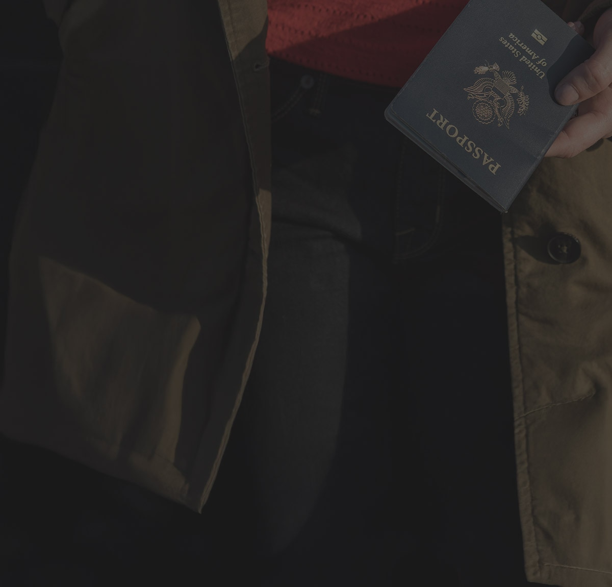 A person holding their passport and other sensitive identifying documents.