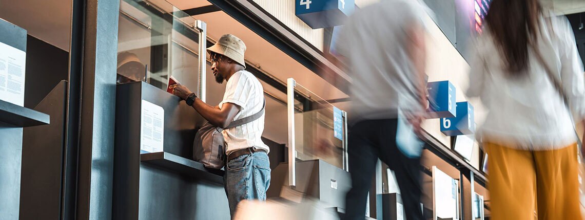Person checking into their flight at the airport, potentially showing their REAL ID.