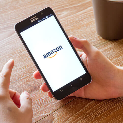A person shopping on Amazon on their phone.