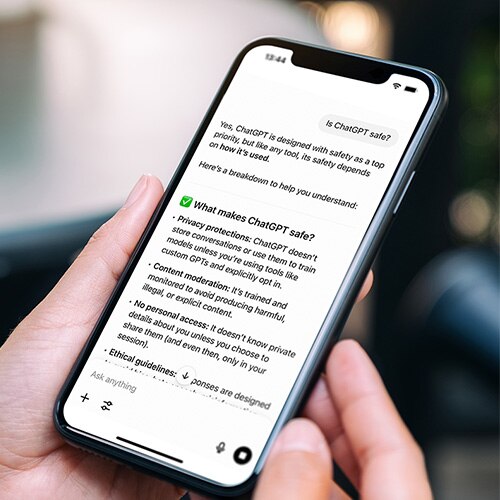 A mobile phone with text on the screen answering whether ChatGPT is safe and why.